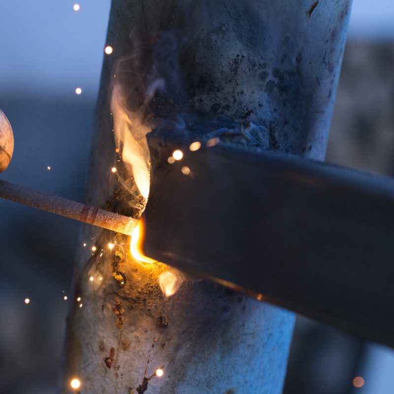 worker welding metal elements on site,image of a